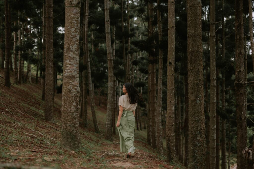 Olumis Studio founder walking through a forest, featured in a blog post about creating a brand identity that feels authentic.