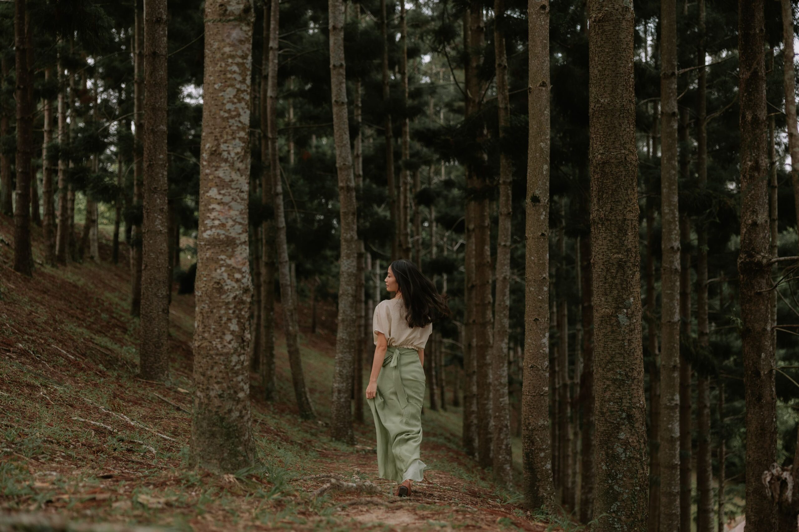 Olumis Studio founder walking through a forest, featured in a blog post about creating a brand identity that feels authentic.